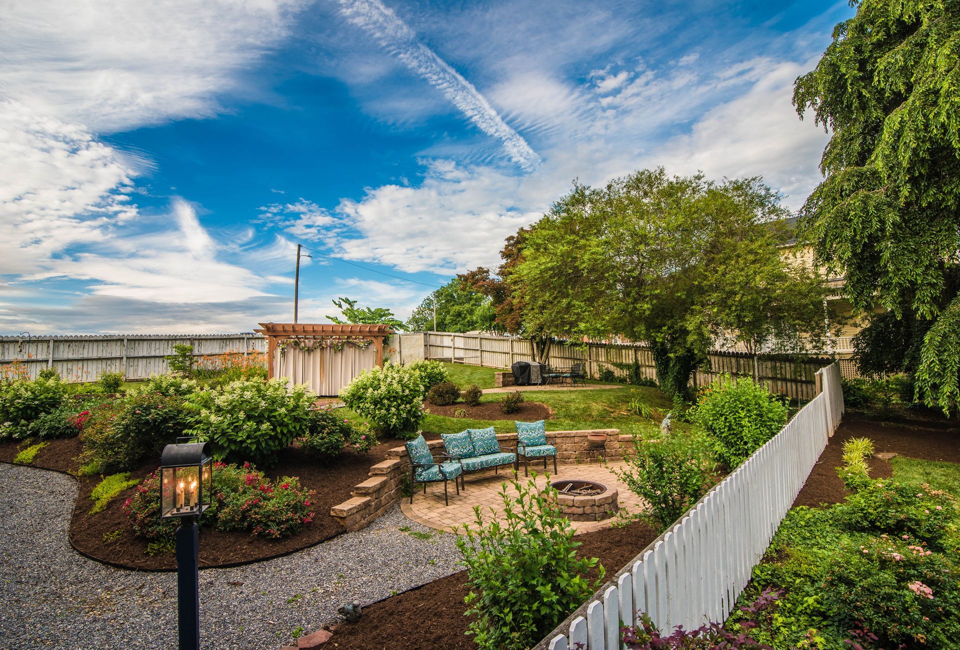 There is a fire pit in the middle of the backyard.