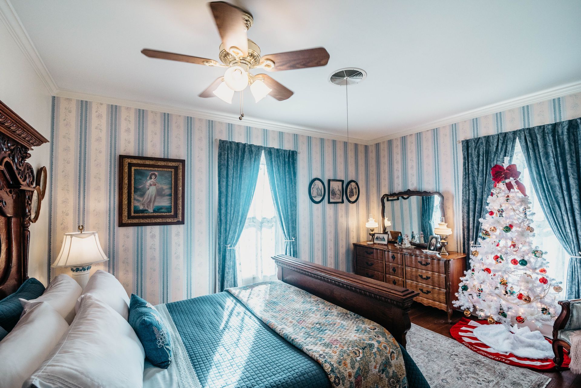 There is a christmas tree in the middle of the room.