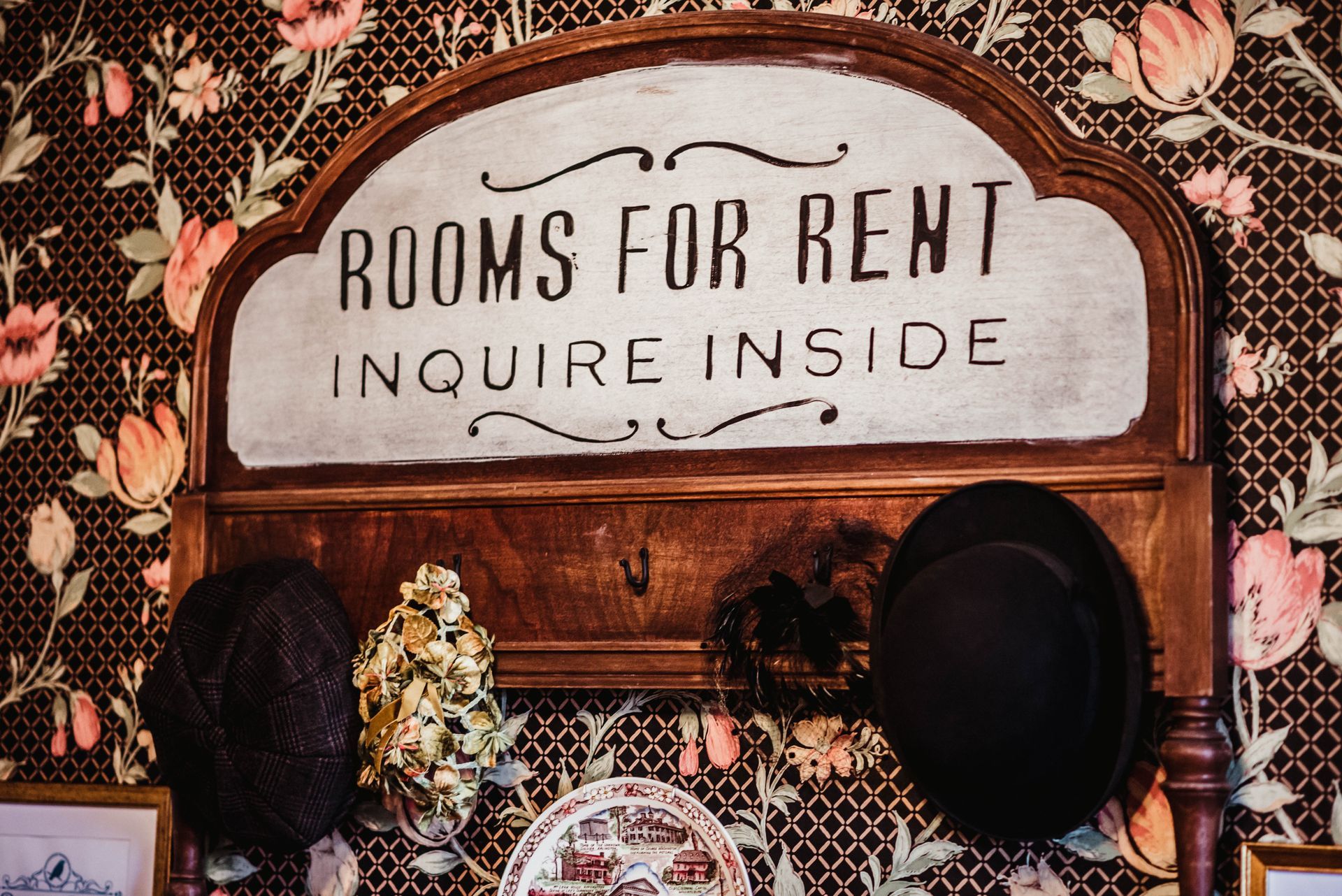 A sign on a wall that says rooms for rent inquire inside