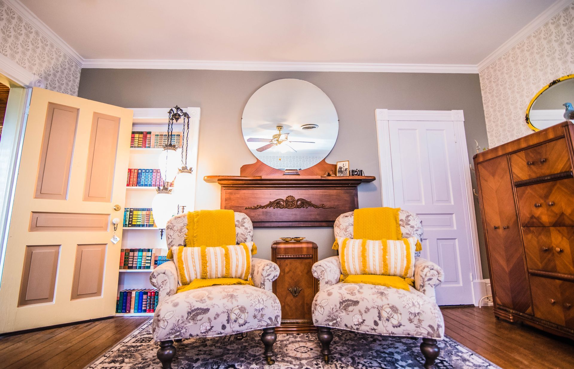 A living room with two chairs and a fireplace.