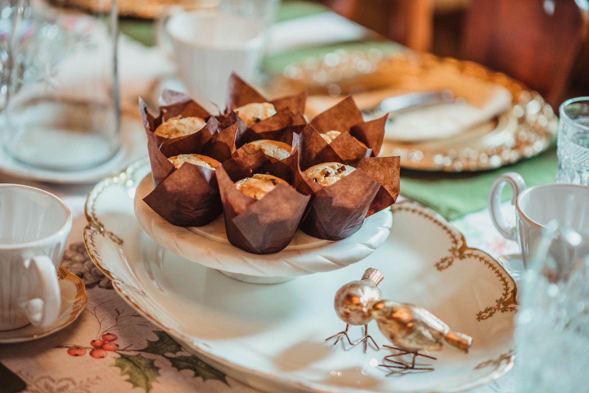 A white plate topped with cupcakes on a table.