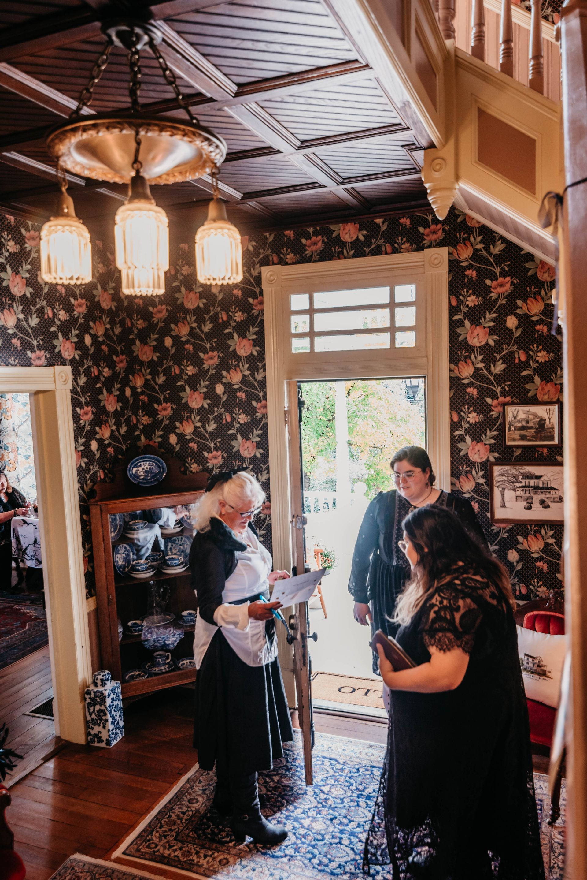 A group of people are standing in a room in front of a door.