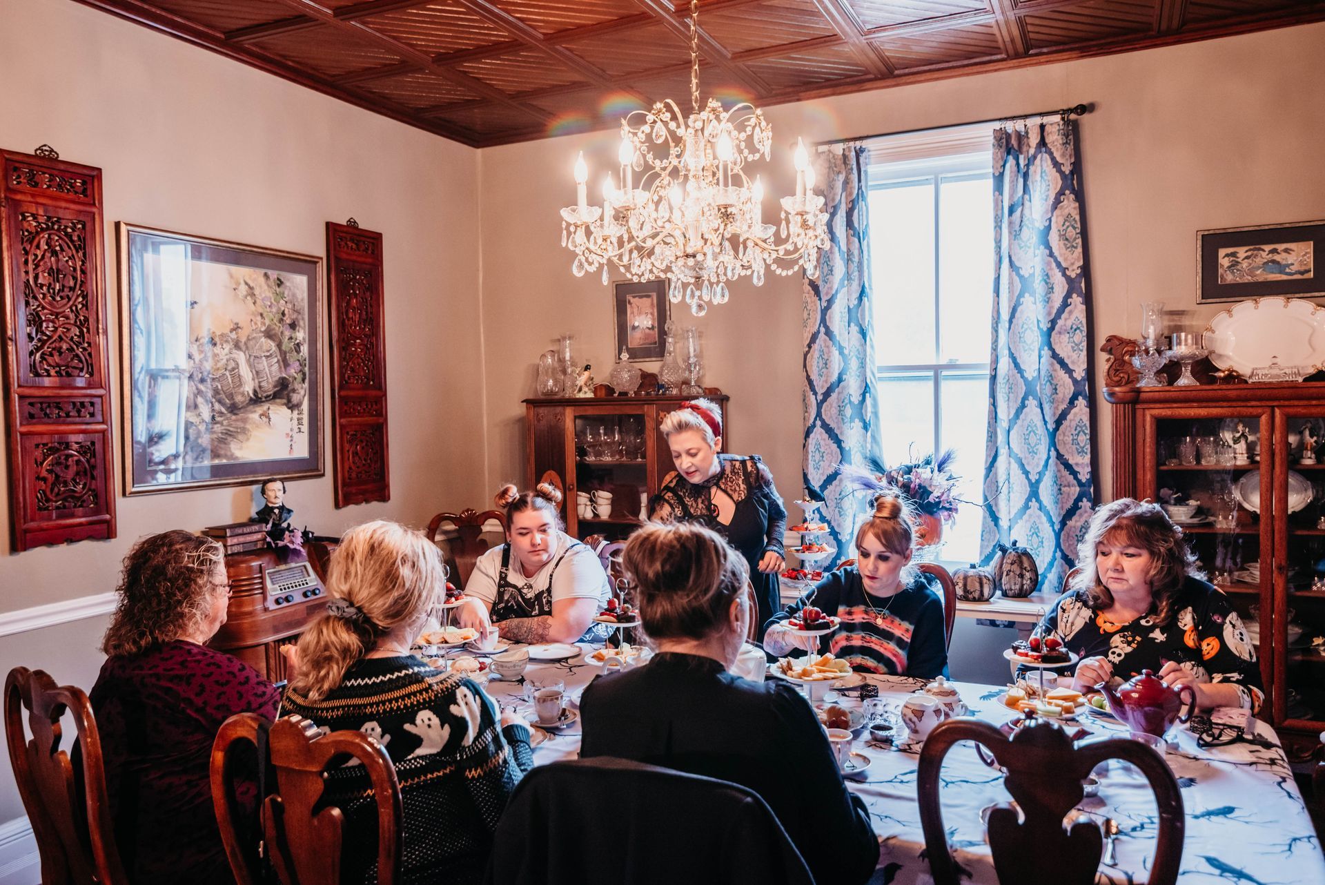 A group of people are sitting around a table in a dining room.