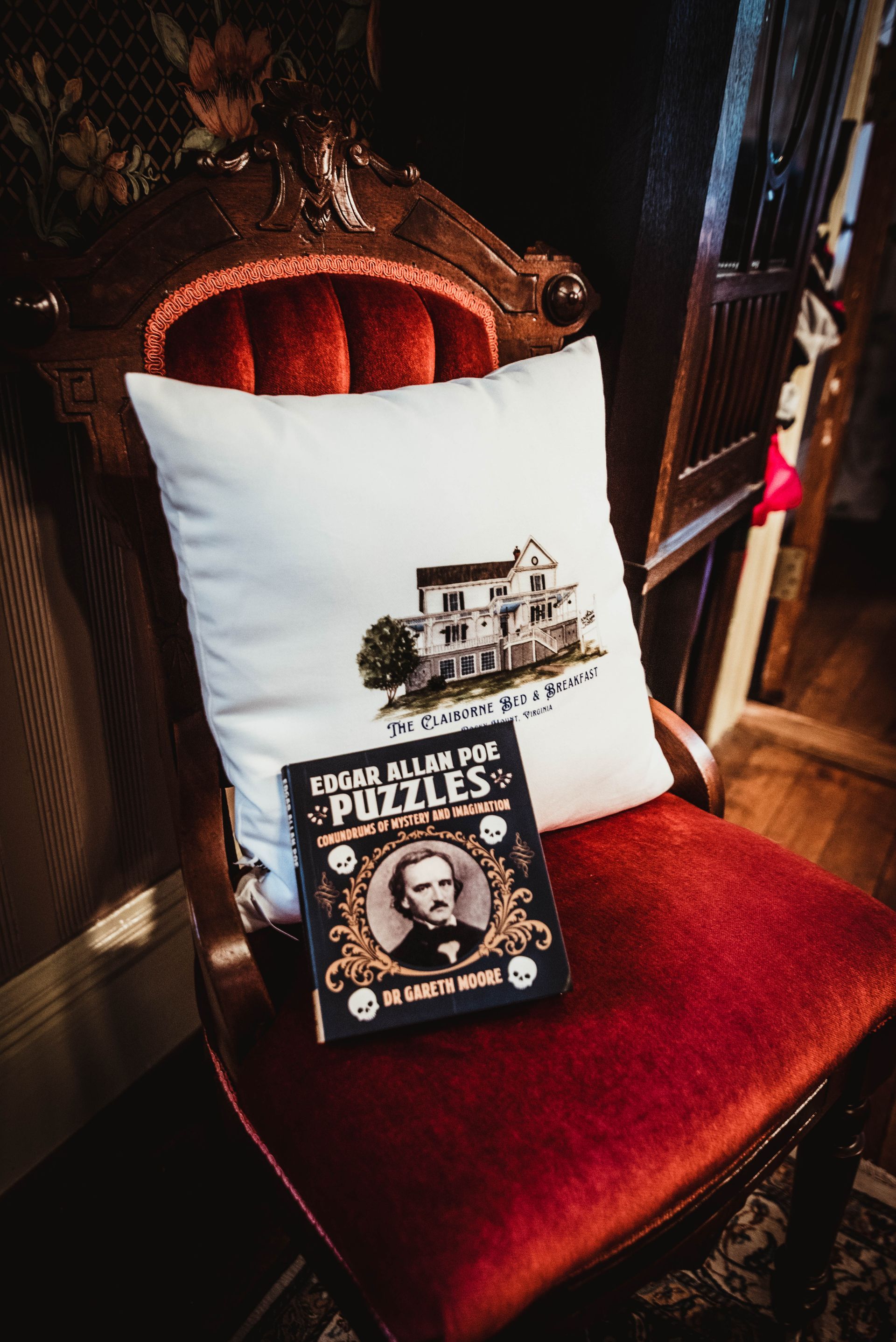 A chair with a pillow and a book on it.