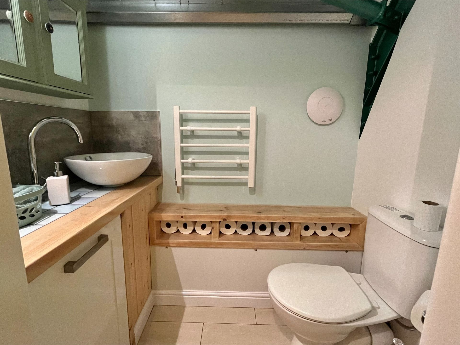 Deanslade bathroom with a toilet , sink and towel rack