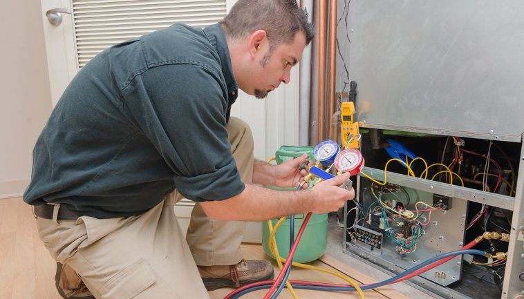 Professional Worker Repairing Furnace Unit — St. Charles, MO — Missouri Furnace & Air Conditioning