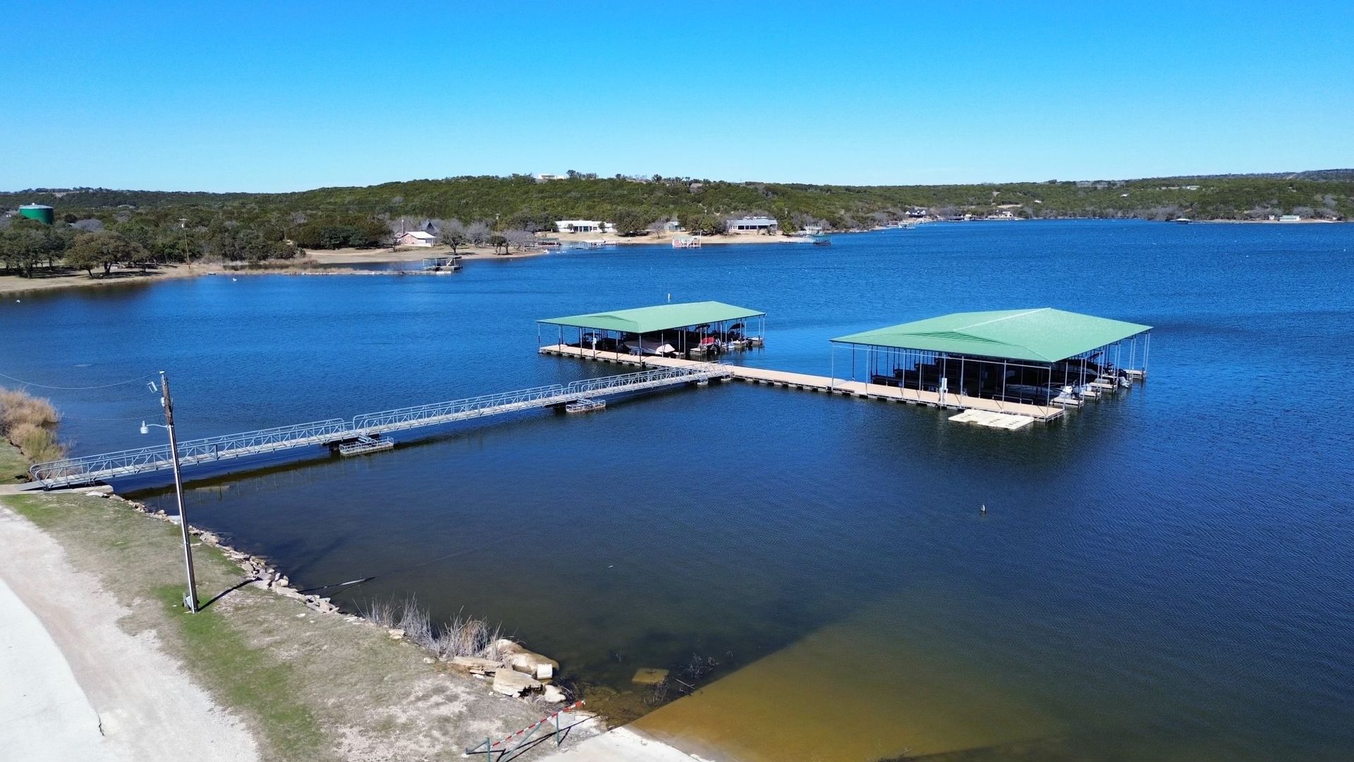 A large body of water with a dock in the middle of it.