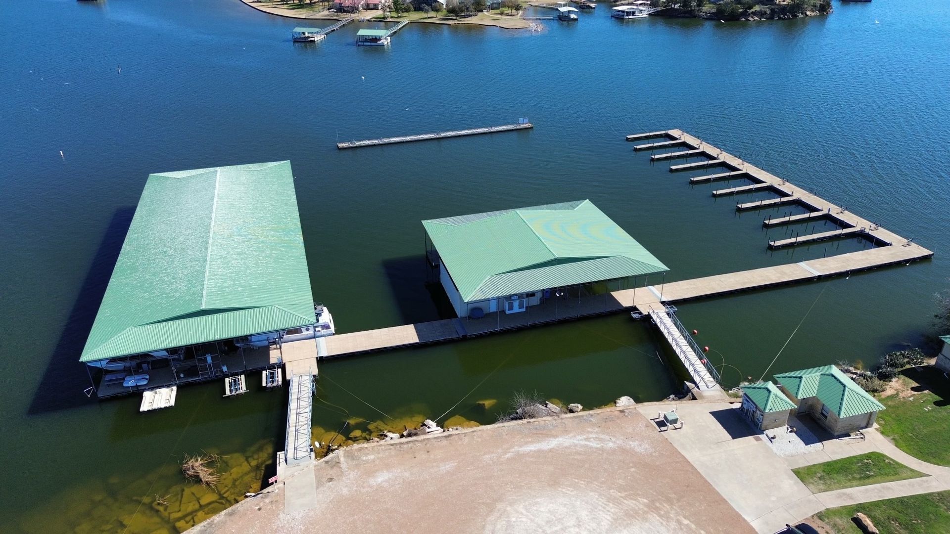 An aerial view of a marina with green roofs