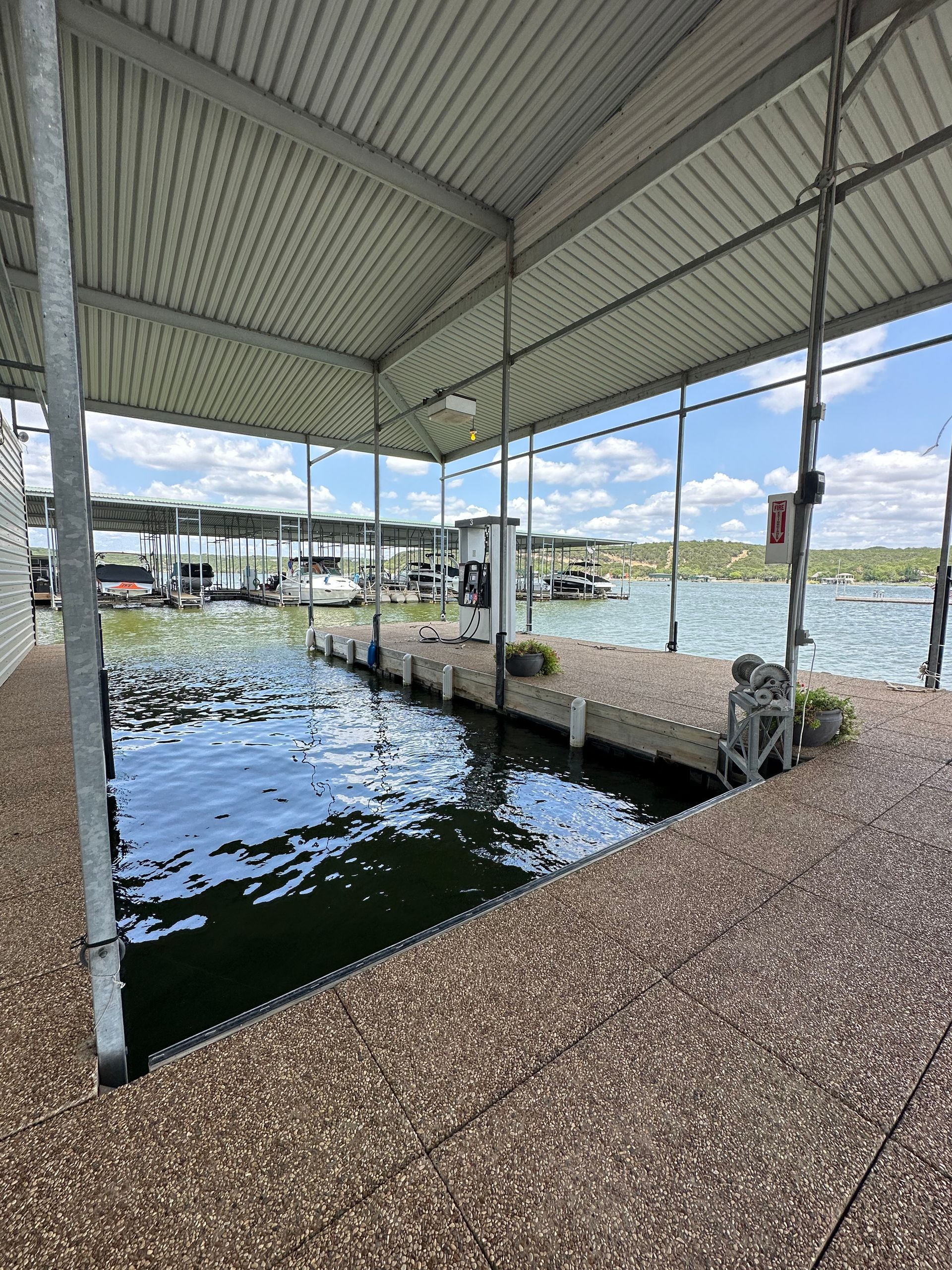 A dock with a covered area overlooking a body of water.
