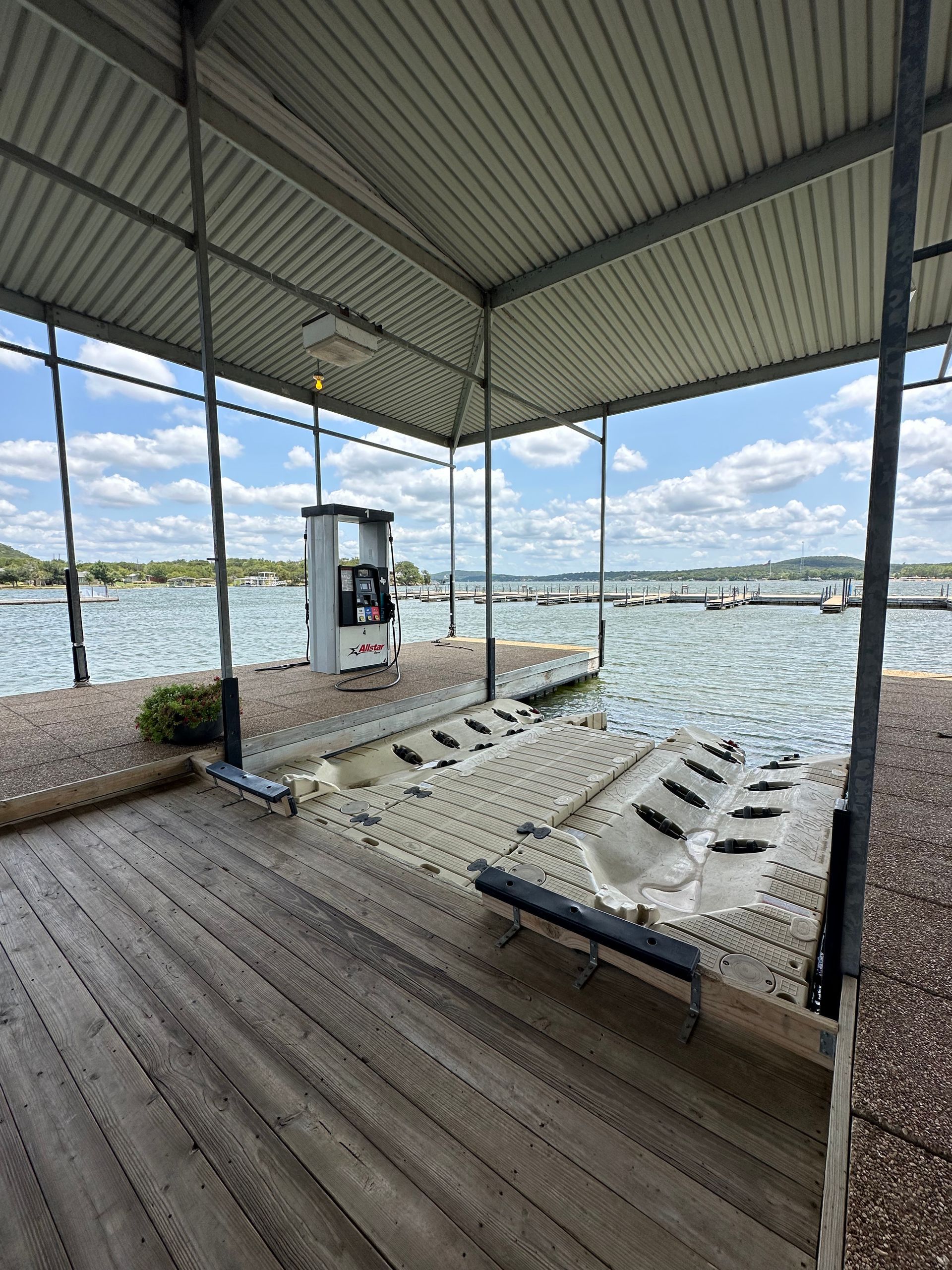 A covered dock with a view of a lake.