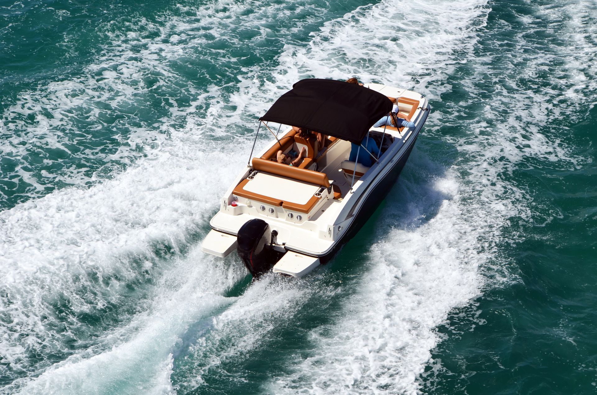 A boat with a black roof is floating on the water