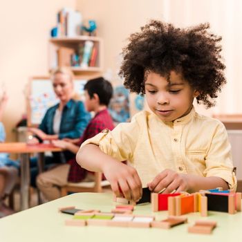 Little boy solving a puzzle