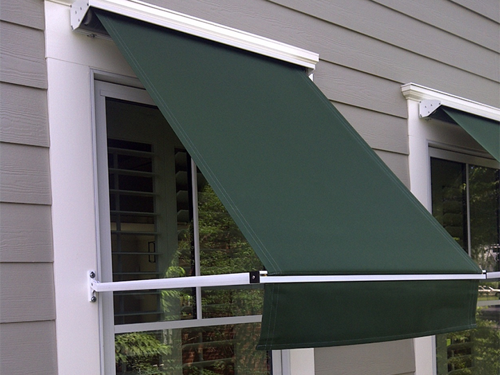 Green awning over a window on a gray-sided building