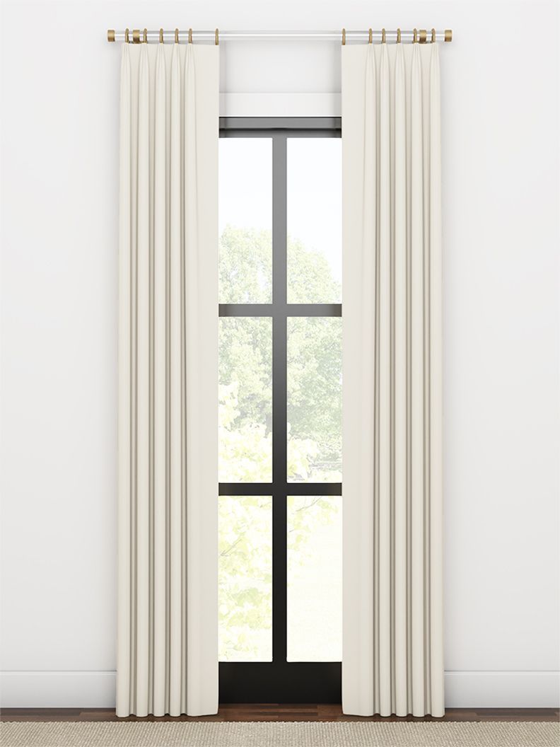 White curtains framing a tall black-framed window in a bright minimalist room