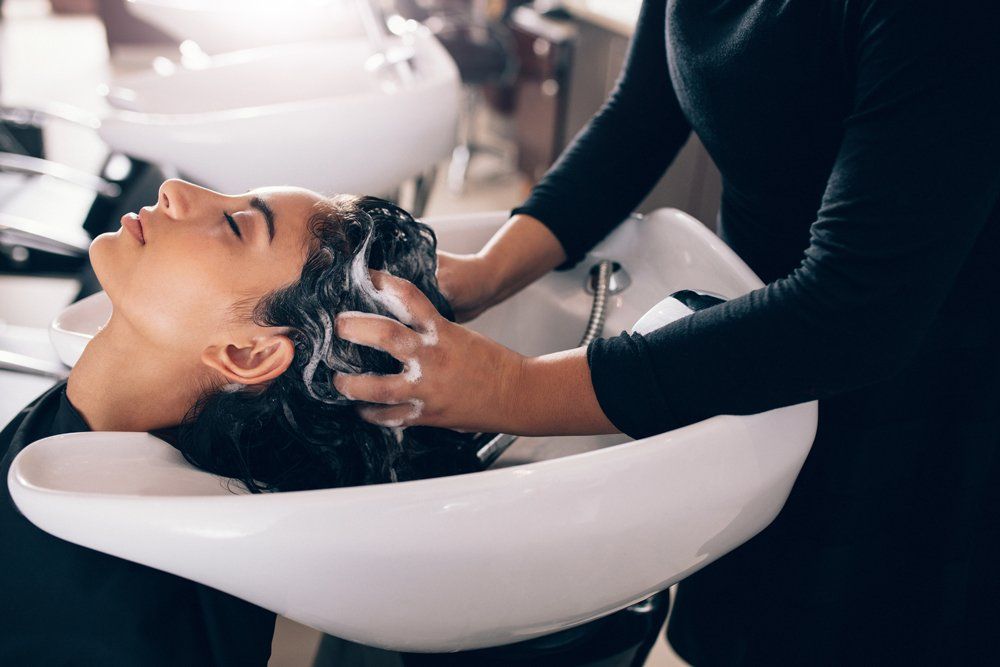 Salon Treatments — Woman Get shampooed at Hair Salon in Houma, LA