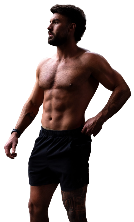 Liam Reardon stands against a white background, wearing black athletic shorts.