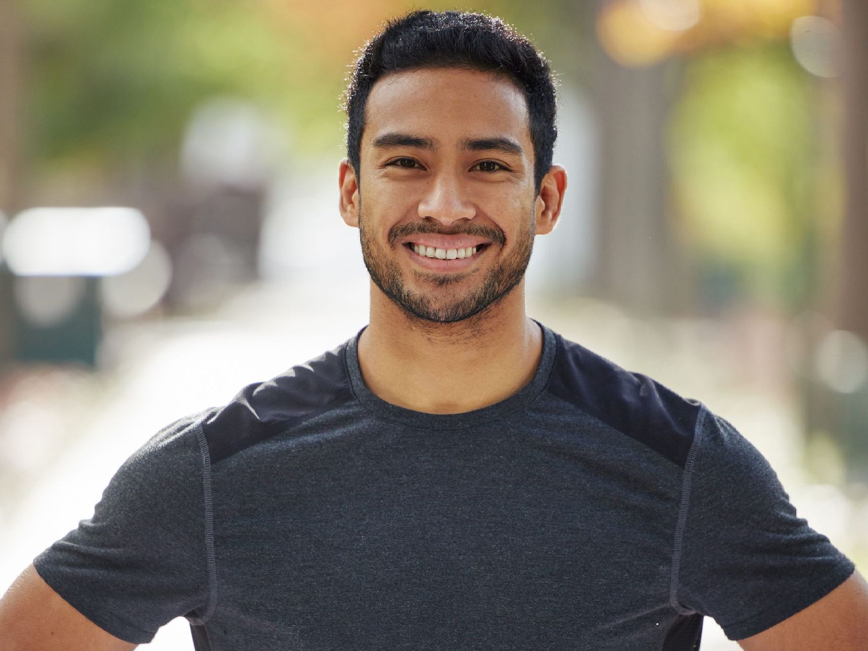 A man with a beard is smiling for the camera