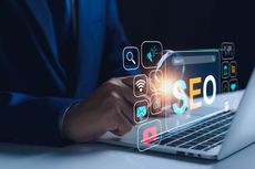A person is using a laptop computer with a virtual screen that says seo.