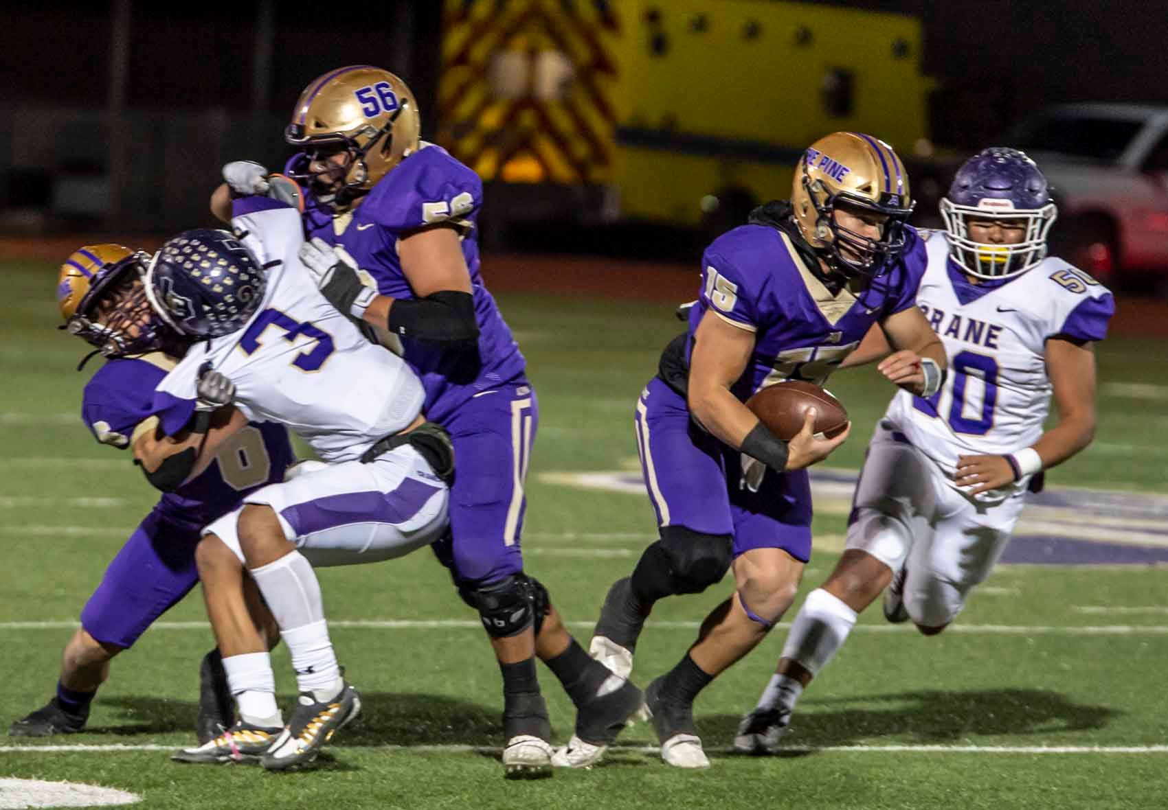 A group of football players are playing a game on a field.