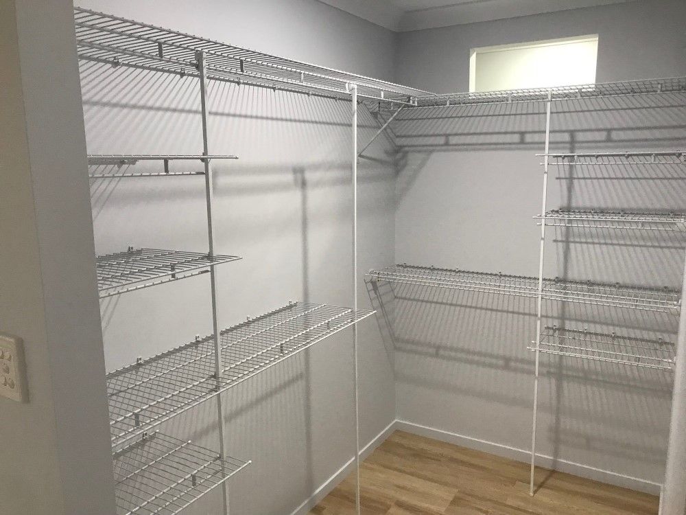 A Walk in Closet With Lots of Shelves and a Window — Wardrobe World In Paget, QLD