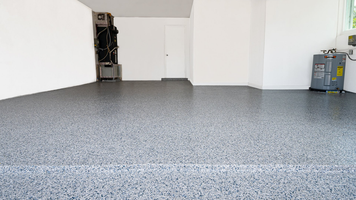 A garage with a gray floor and white walls.