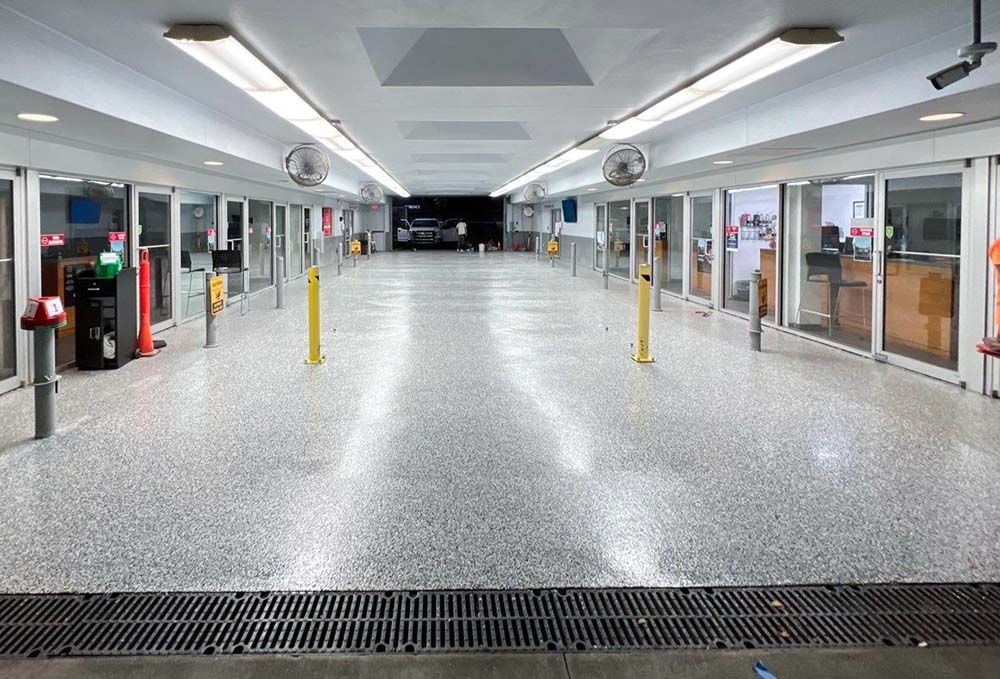 An empty parking garage with a lot of windows and lights.