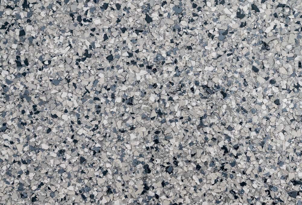 A close up of a gray and black granite counter top.