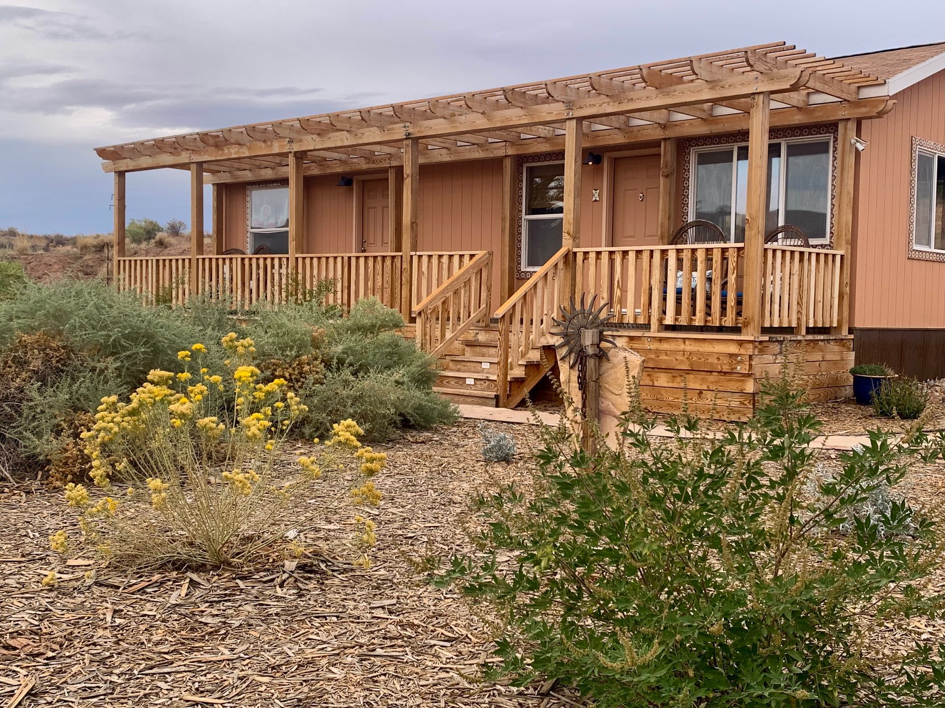 A mobile home with a large porch and stairs