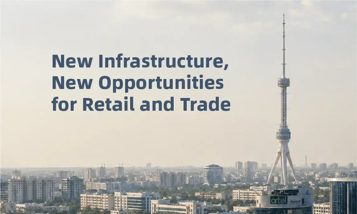 City skyline with a tall tower and the text “New Infrastructure, New Opportunities for Retail and Trade”
