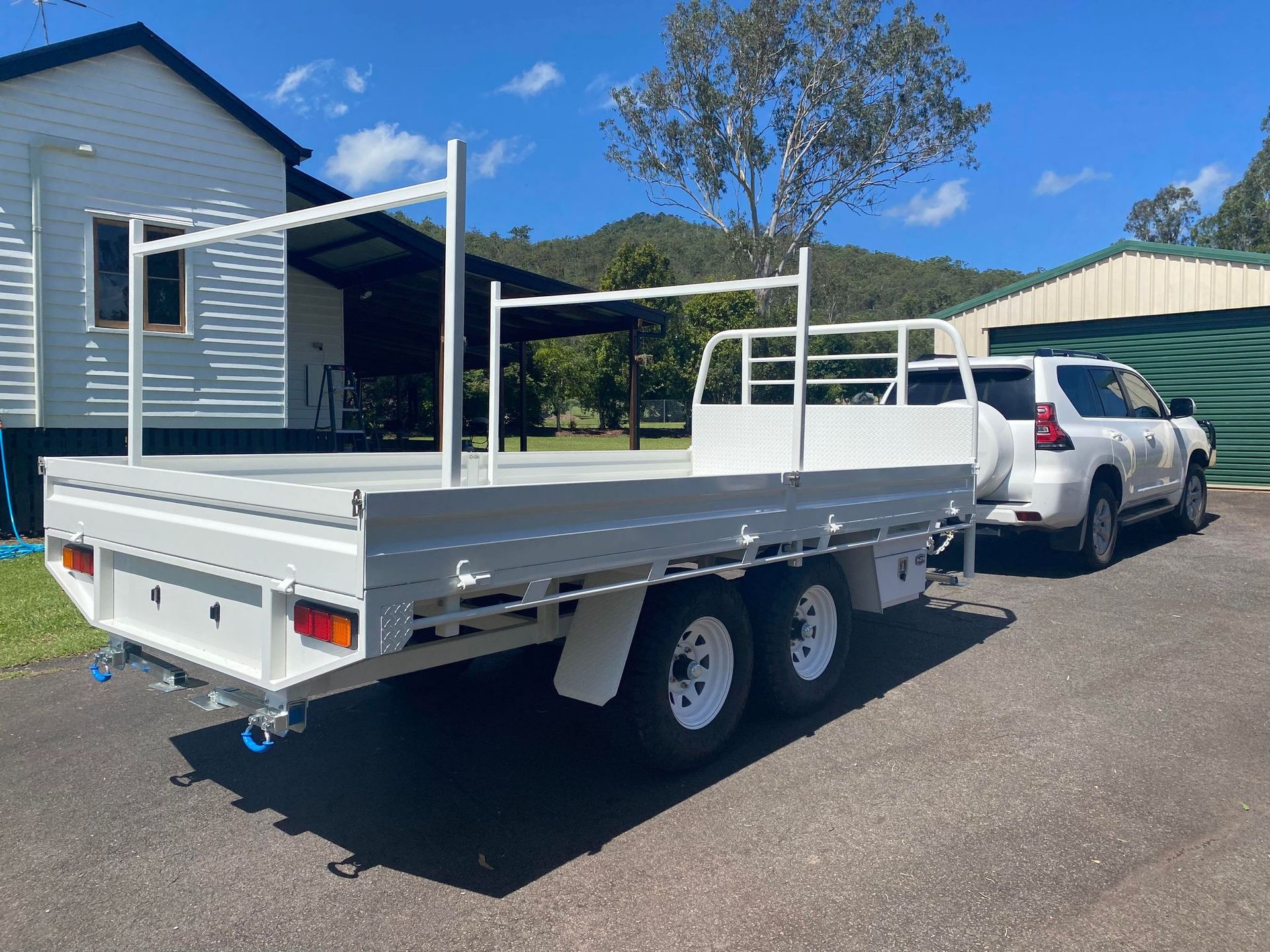 White Flatbed Trailer Hitched to a White Suv — Australian Mobile Welding Pty Ltd in Atherton, QLD