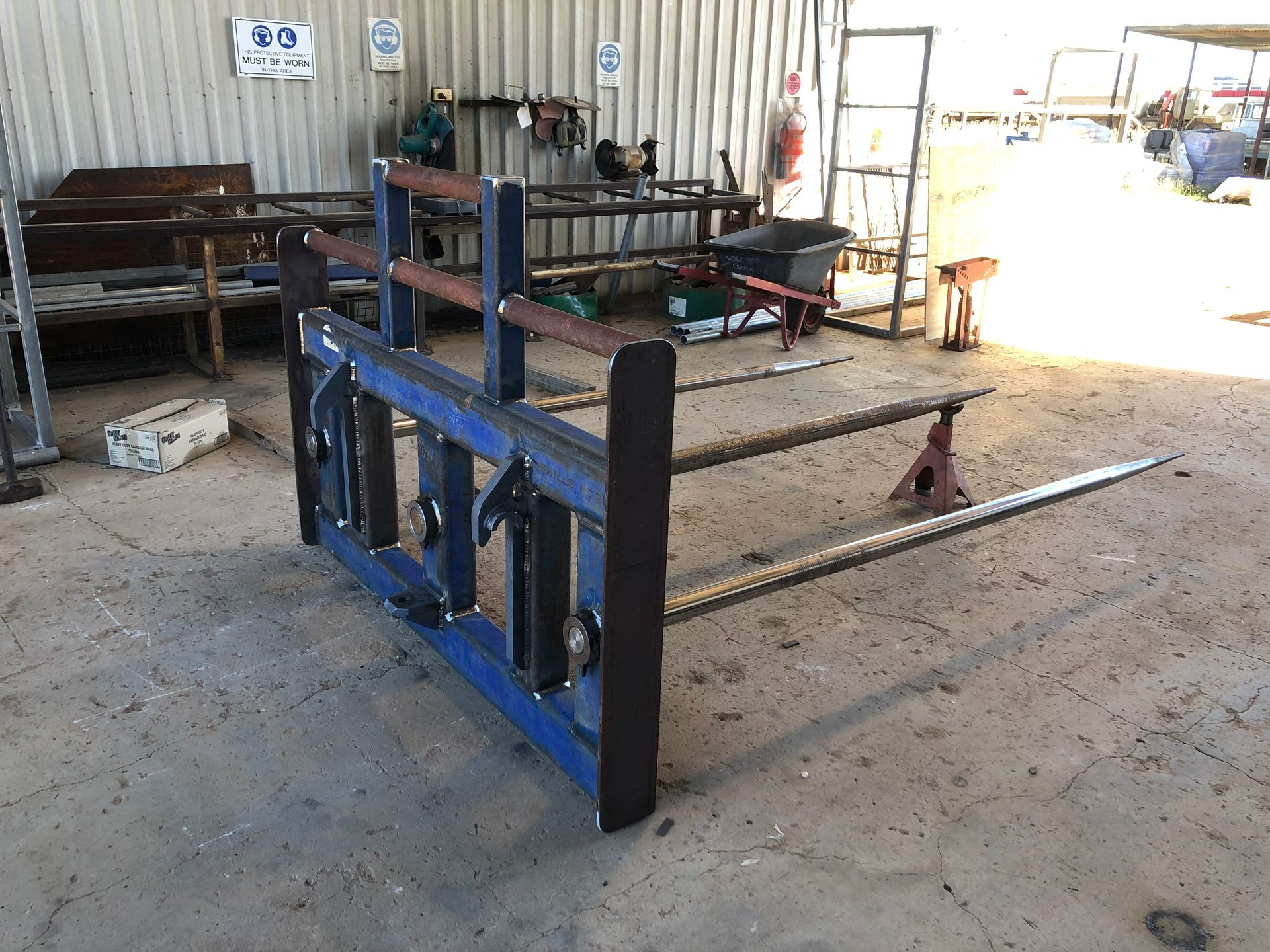 Blue and brown metal hay bale spear in a workshop — Australian Mobile Welding Pty Ltd in Georgetown, QLD
