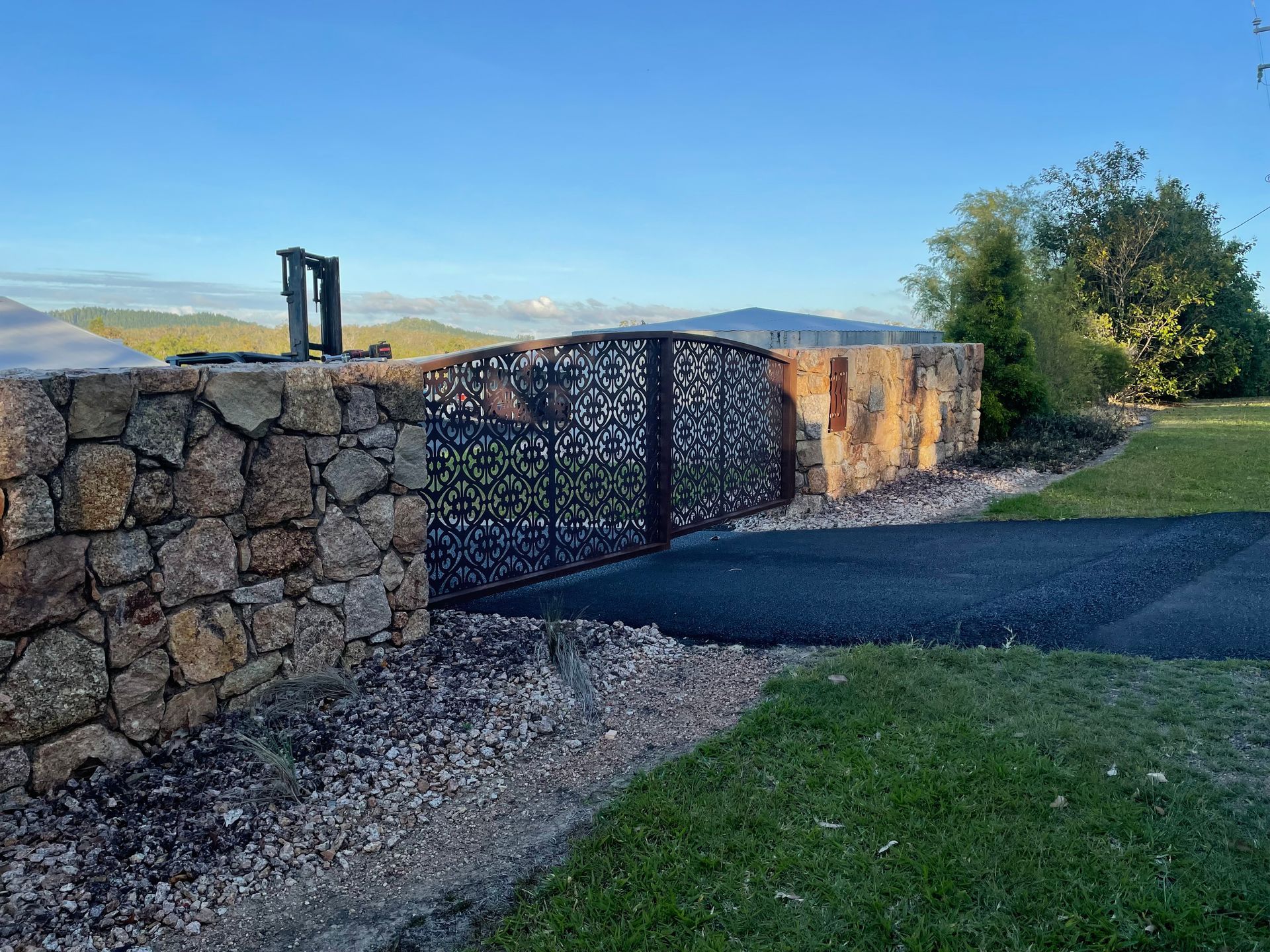 Metal frame on sawhorses inside a metal building, with one blue and one white sawhorse — Australian Mobile Welding Pty Ltd in Normanton, QLD