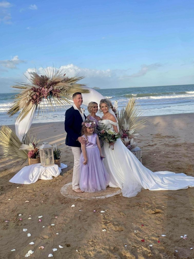 A Man In A Suit And Tie Stands Next To A Woman — Carolynn Farmer-Celebrant In Emu Park, QLD