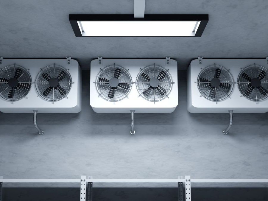 Three industrial cooling units mounted on a gray wall.