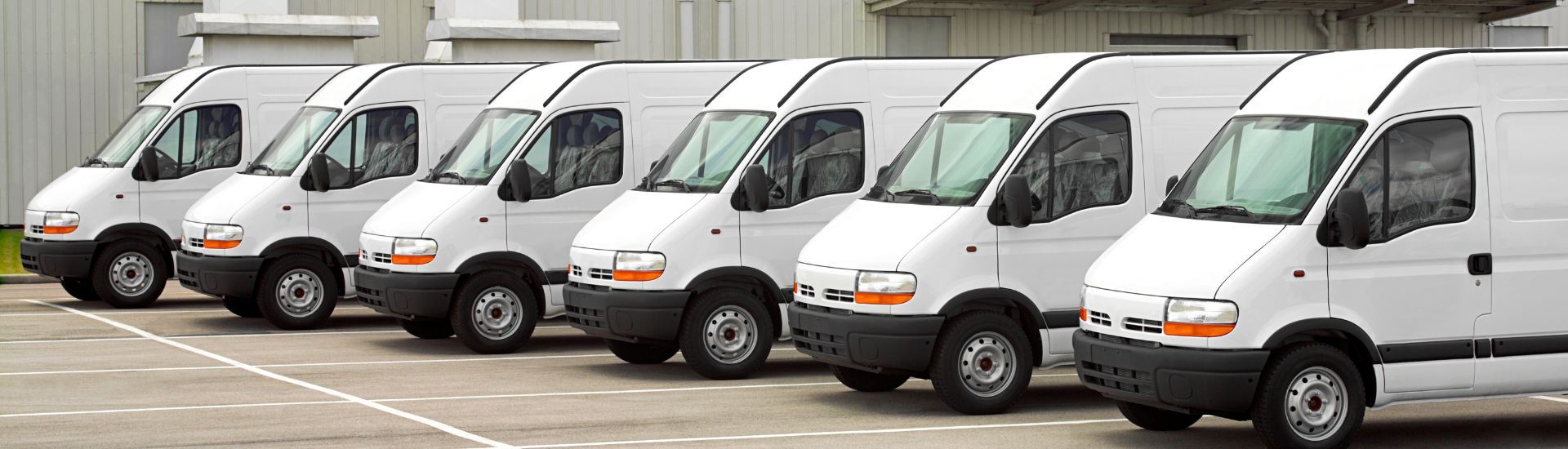 White delivery vans parked in a row. | The Garage Automotive Solutions