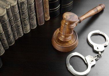Judges Gavel, Handcuffs And Old Book On The Black Table - Bail Bonds in Houston, TX