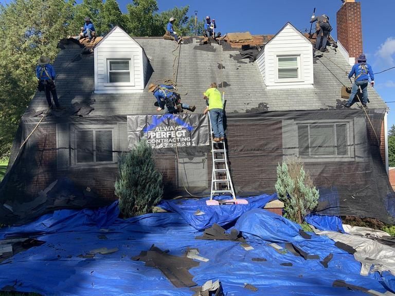 Rotting wood being removed from a roof gutter with a power saw.
