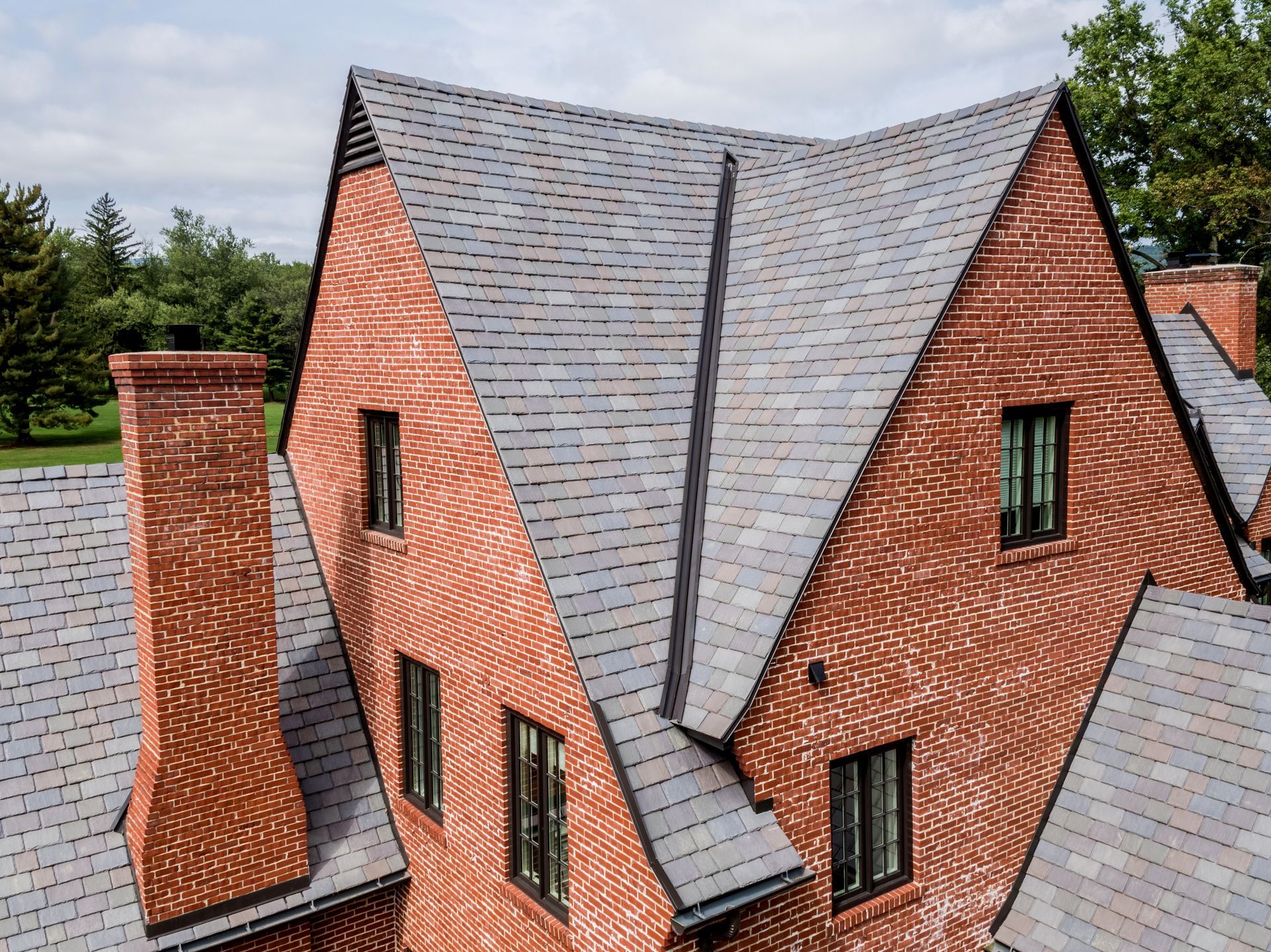Brown asphalt shingle roof on a house with a multi-toned color pattern.