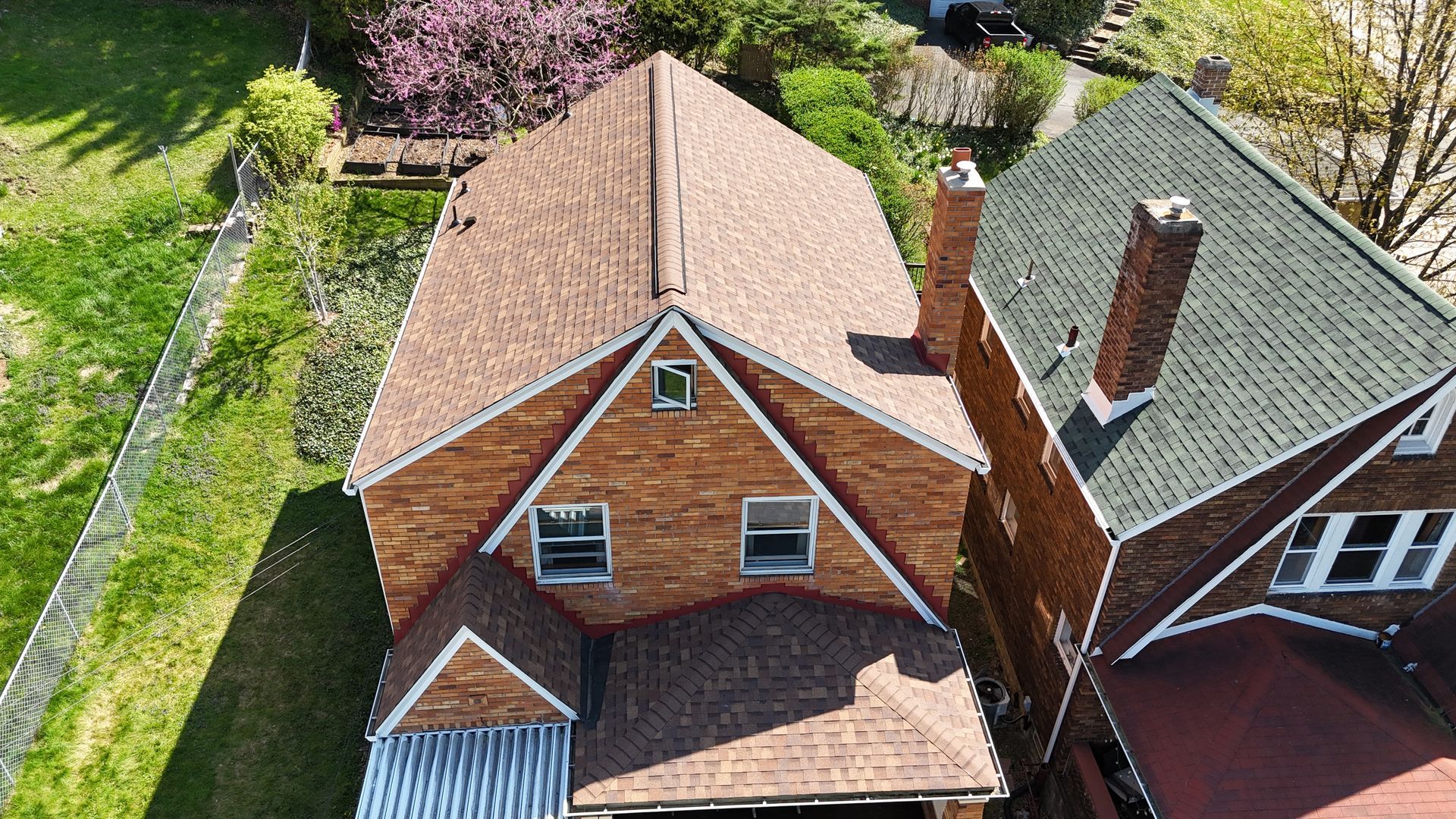 Exterior view of a cinder block building with a brown roof and a window. A gutter runs along the roofline.