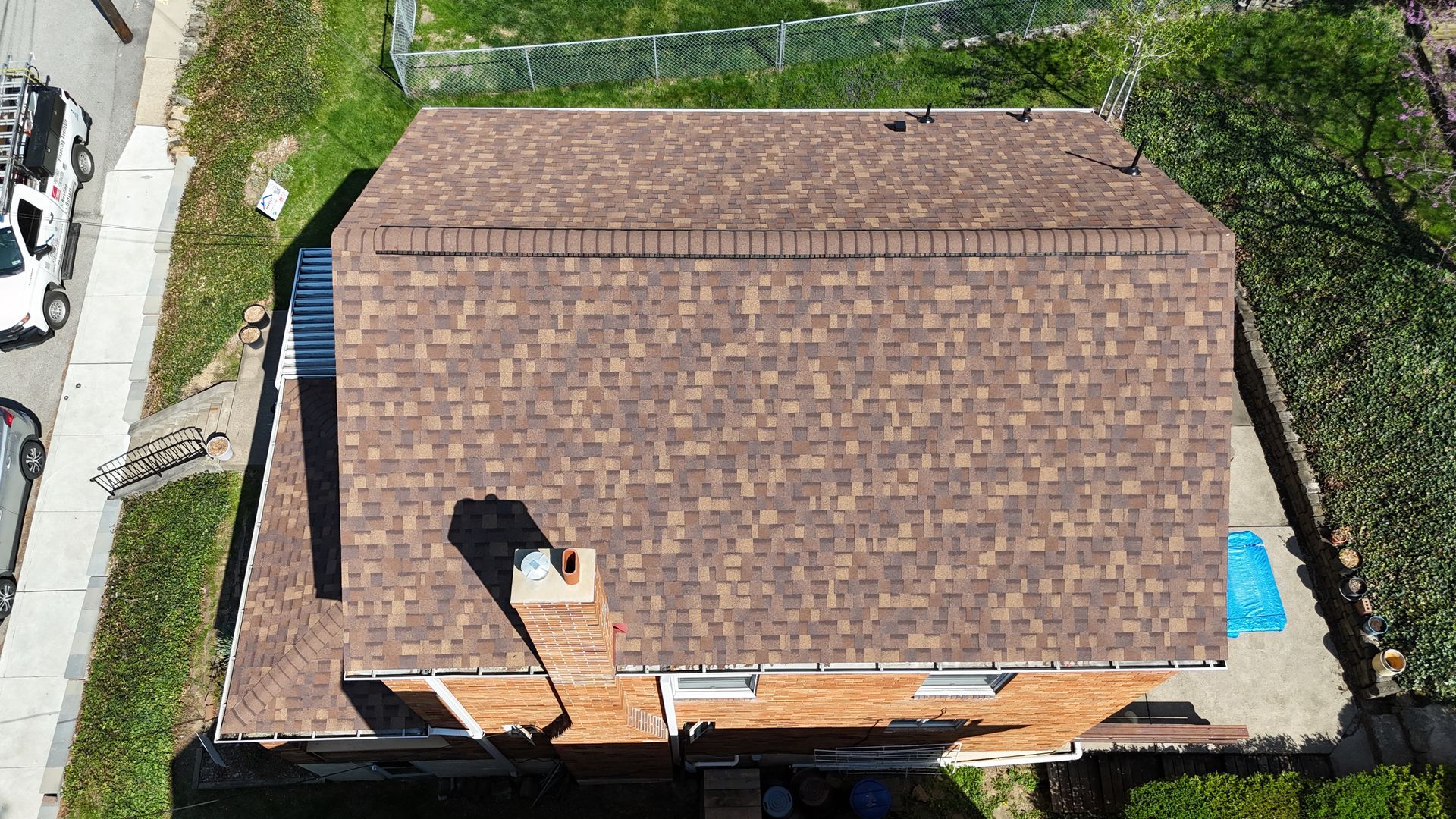 White built-in shelves under a window. White walls, wood floor, and small fireplace on the right.