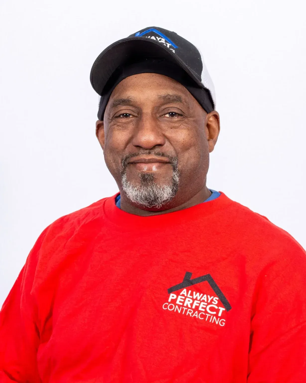 Man wearing a cap and red sweatshirt with 