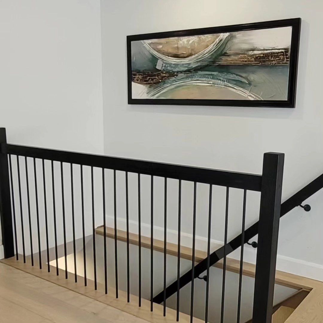 There is a picture of a boat on the wall above the stairs.