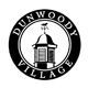 The dunwoody village logo is a black and white image of a lighthouse in a circle.