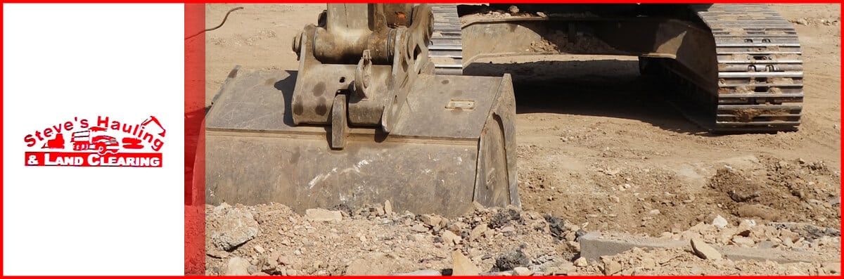 A bulldozer is digging a hole in the dirt.