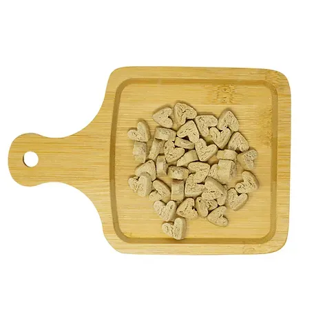 A wooden cutting board with a pile of hearts on it.
