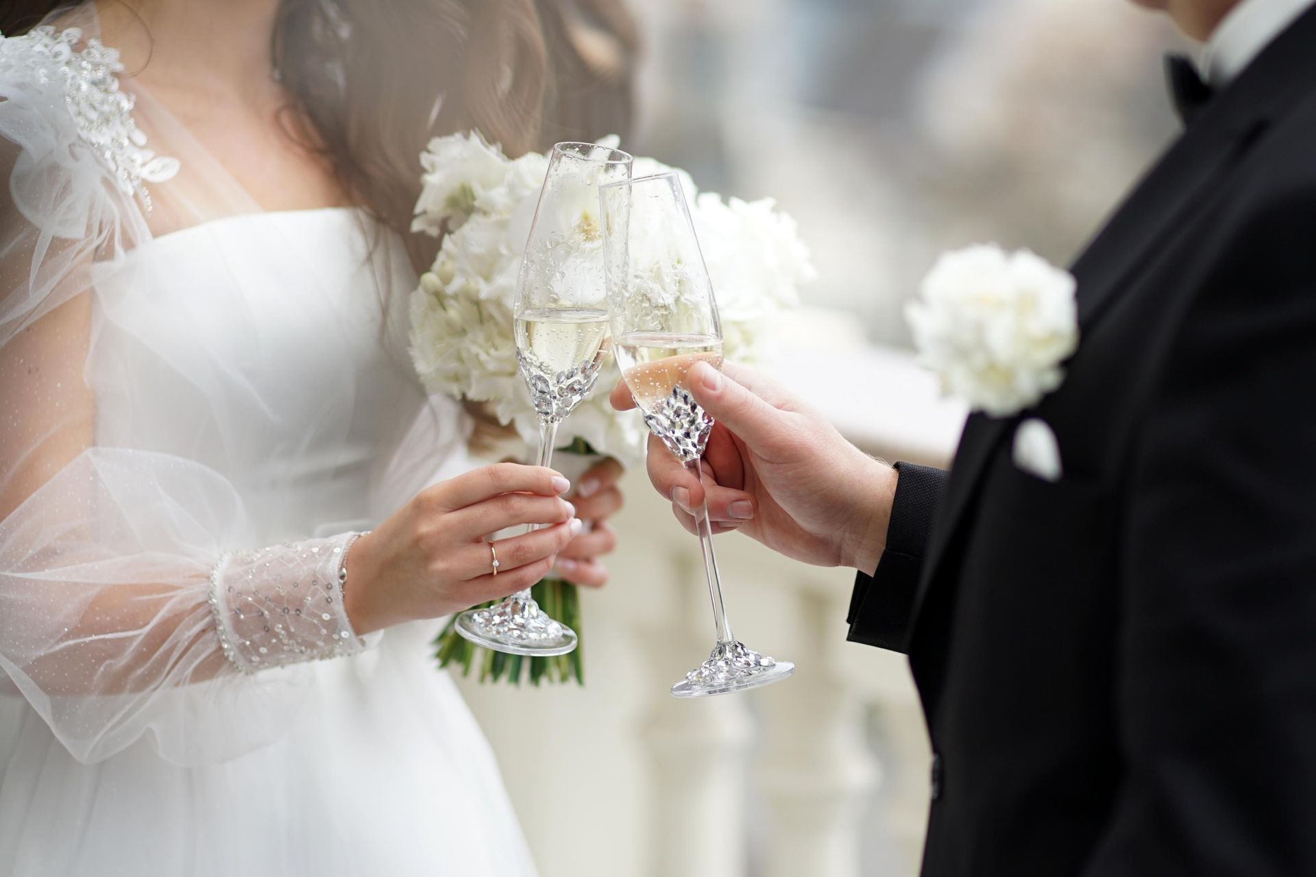 Bride and groom toasting with champagne glasses at a wedding.
