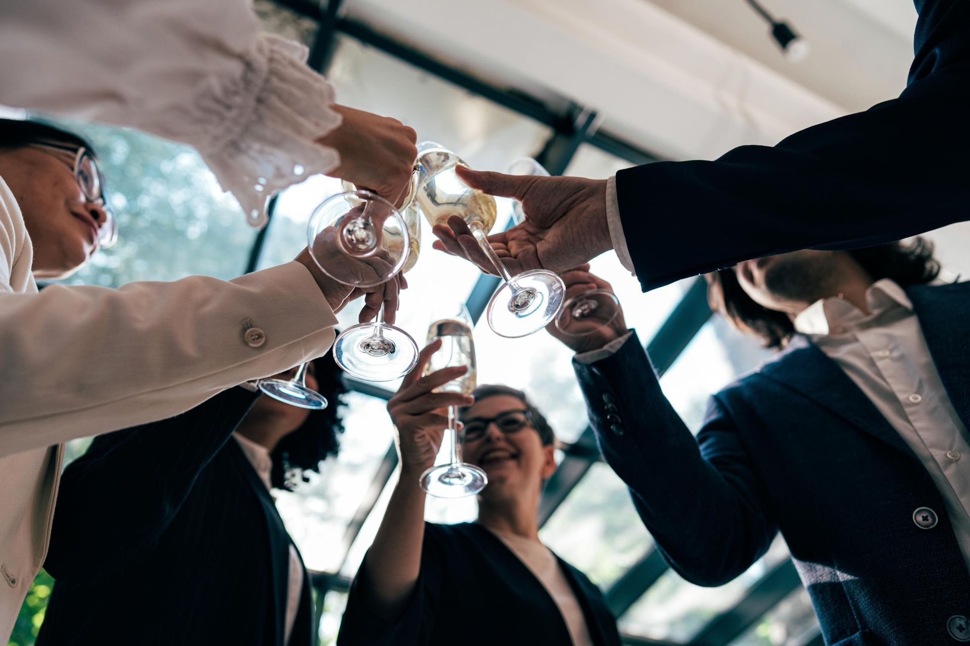 People in formal wear toasting champagne glasses.