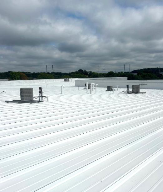 A white roof with a cloudy sky in the background.
