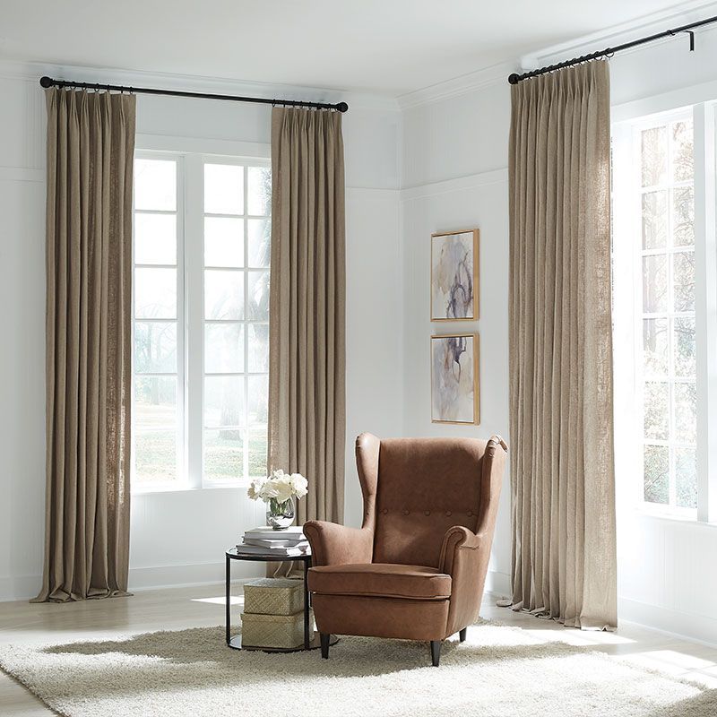 Dining room with long dining table and chair set with custom solar shades.