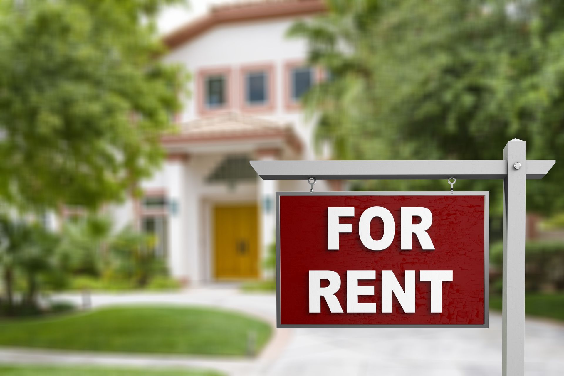 A red for rent sign is hanging in front of a house.